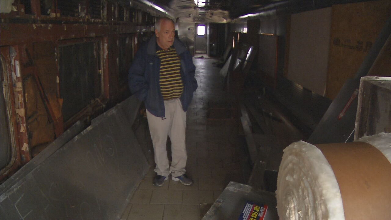 John Owen stands inside an abandoned train car in Charlestown, Indiana
